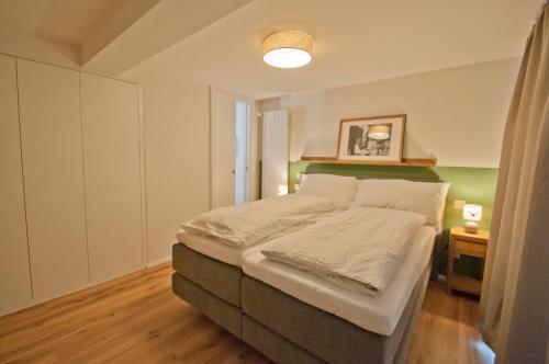 a bedroom with a large bed in a room at Chalet Aeschhorn in Zermatt