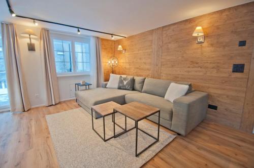 a living room with a couch and a table at Chalet Aeschhorn in Zermatt