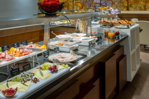 a buffet line with many different types of food at Barcelona Hotel Colonial in Barcelona