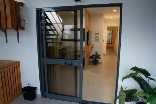 a glass elevator in a hallway with a staircase at Tropical Suite 22 B in Santa Maria