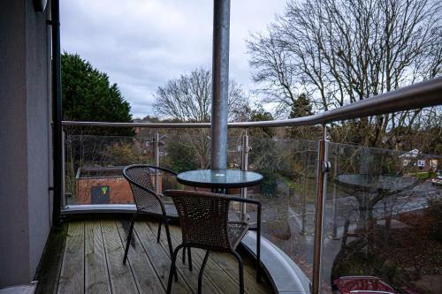 a balcony with a table and chairs on a deck at Spacious 2 Bedroom Apartment in Crawley in Crawley