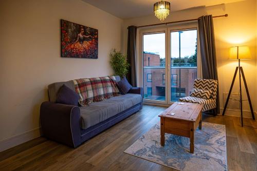 a living room with a couch and a table at Spacious 2 Bedroom Apartment in Crawley in Crawley
