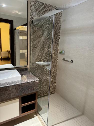 a shower with a glass door in a bathroom at Imperial Plaza Hotel, Juba in Juba