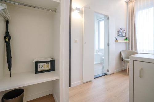 a room with a hallway with a clock on a shelf at Hotel du Bassin in Ostend