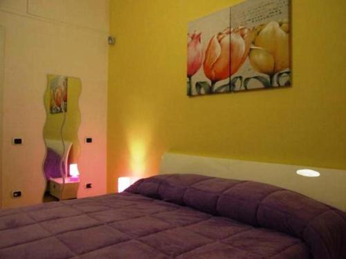 a bedroom with a bed and a painting on the wall at Bed and Breakfast Adelberga in Salerno
