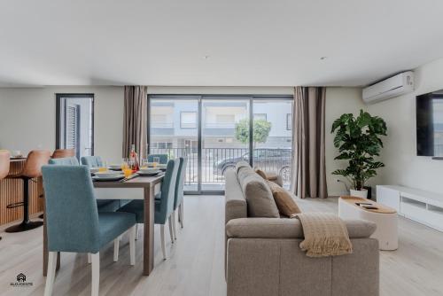 a dining room and living room with a table and chairs at Shore Apartments - Santa Cruz in Santa Cruz