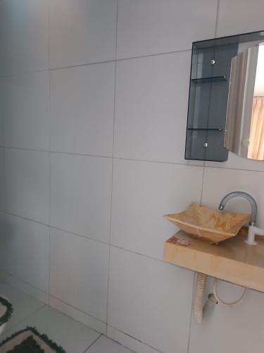 a bathroom with a sink and a mirror at POUSADA MARIA FLOR in Caucaia