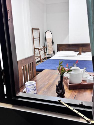 a view of a room with a table and a bed at sun mount adams peak in Adams Peak
