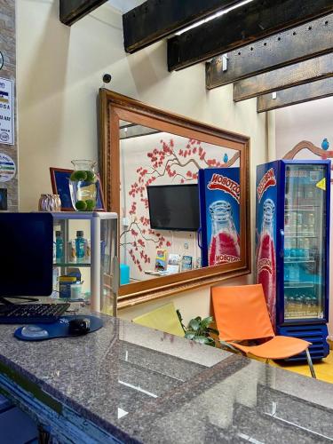 a desk with a mirror and a computer and a chair at Hotel Boutique Stay La 10 in Medellín