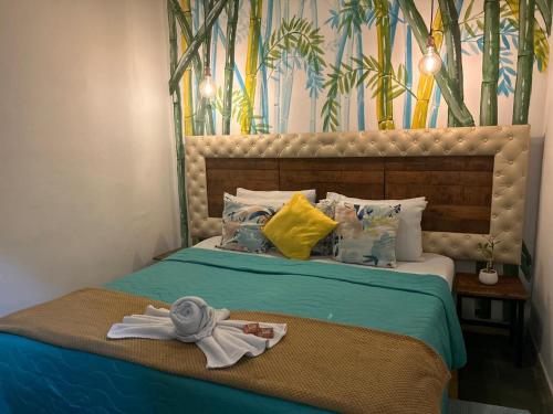 a bedroom with a bed with towels on it at Hotel Boutique Stay La 10 in Medellín