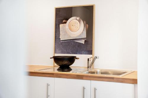 a kitchen counter with a sink and a mortar and pestle at Luxury 2BR in Media City in Manchester