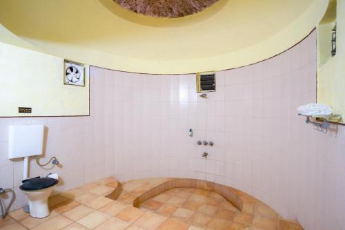 a bathroom with a toilet and a sink at Treebo Premium Mowgli's Den, Pench in Khawāsa