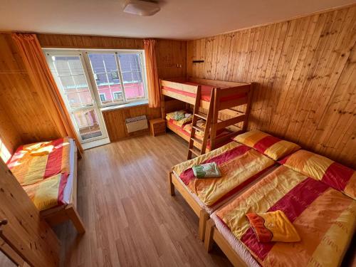 a room with two bunk beds and a window at Penzion pod Vlekem Dolní Morava in Dolní Morava