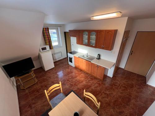 an overhead view of a kitchen with a table and chairs at Penzion pod Vlekem Dolní Morava in Dolní Morava