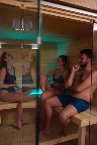 a group of people sitting in a sauna at Lake Hotel La Pieve in Pisogne