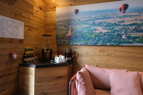a room with a wall with a picture of hot air balloons at Lake Hotel La Pieve in Pisogne