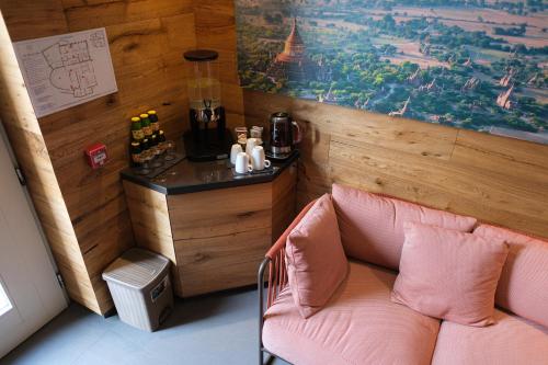 a room with a pink chair in a room with a counter at Lake Hotel La Pieve in Pisogne