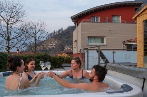 a group of people in a hot tub with champagne at Lake Hotel La Pieve in Pisogne