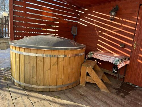 a sauna with a wooden tub and a bench at Penzion pod Vlekem Dolní Morava in Dolní Morava