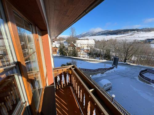 a balcony with a view of a snow covered yard at Penzion pod Vlekem Dolní Morava in Dolní Morava