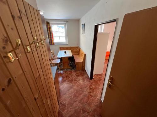 a hallway of a room with a table and a window at Penzion pod Vlekem Dolní Morava in Dolní Morava