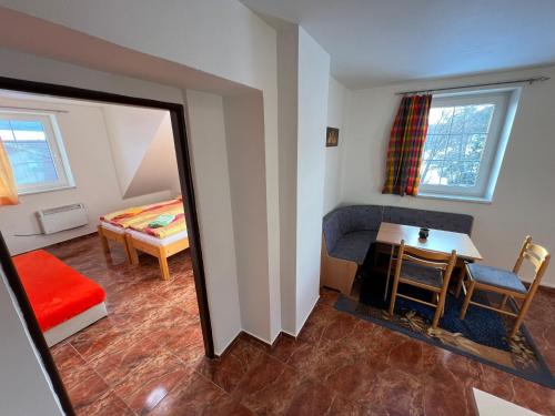a room with a mirror and a table and a bed at Penzion pod Vlekem Dolní Morava in Dolní Morava