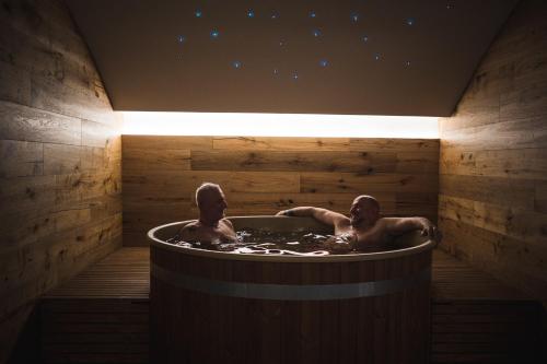 two men in a jacuzzi tub at night at Lake Hotel La Pieve in Pisogne