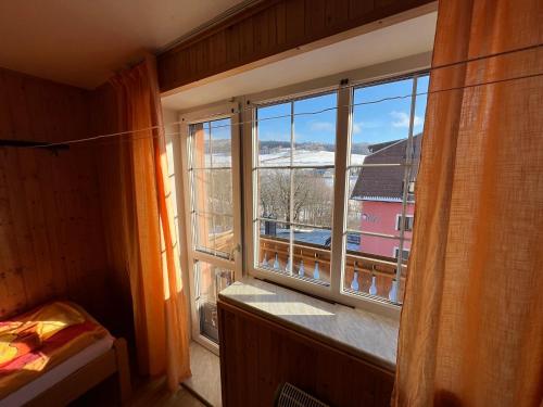 a room with a window with a view of a snow covered mountain at Penzion pod Vlekem Dolní Morava in Dolní Morava