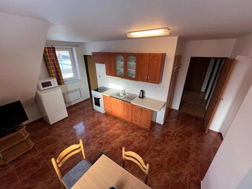an overhead view of a kitchen with a table and chairs at Penzion pod Vlekem Dolní Morava in Dolní Morava