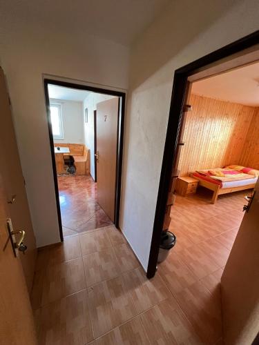a room with a door and a room with a bed at Penzion pod Vlekem Dolní Morava in Dolní Morava