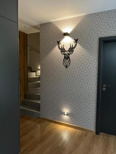 a hallway with a light fixture on a wall at CHALETY MÝTO POD ĎUMBIEROM in Mýto pod Ďumbierom