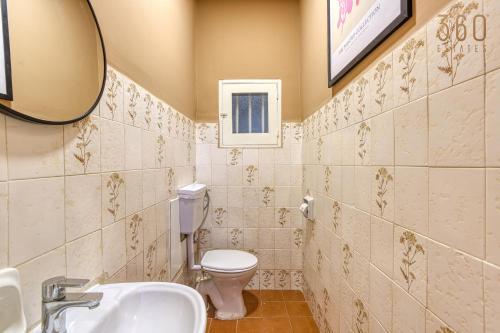 a bathroom with a toilet and a sink and a mirror at Maltese Maisonette in Historic Isla with Sea Views by 360 Estates in Senglea