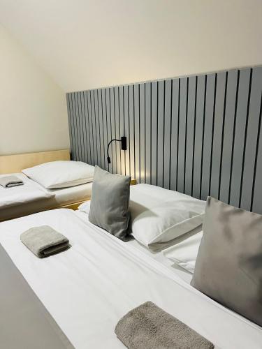two beds sitting next to each other in a room at CHALETY MÝTO POD ĎUMBIEROM in Mýto pod Ďumbierom