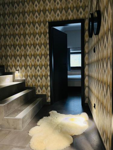a hallway with stairs and a door with a rug at CHALETY MÝTO POD ĎUMBIEROM in Mýto pod Ďumbierom