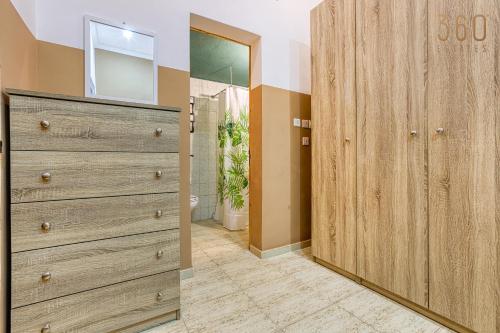 a bathroom with a large wooden dresser in a room at Maltese Maisonette in Historic Isla with Sea Views by 360 Estates in Senglea