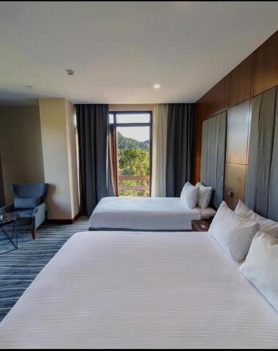 a hotel room with two beds and a window at Yalçın Resort Hotel in Korgan