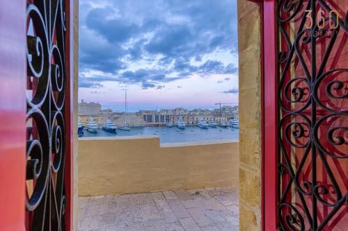 a view of a harbor from a window with boats in the water at Maltese Maisonette in Historic Isla with Sea Views by 360 Estates in Senglea