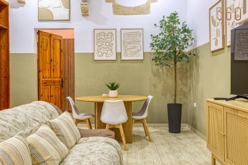 a living room with a couch and a table at Maltese Maisonette in Historic Isla with Sea Views by 360 Estates in Senglea