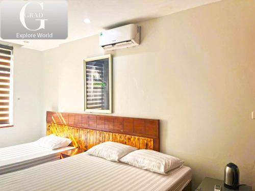 a bedroom with two beds and a heater on the wall at Hanoi Gold Hotel in Hanoi