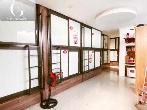 a large room with windows and a red object in the middle at Hanoi Gold Hotel in Hanoi