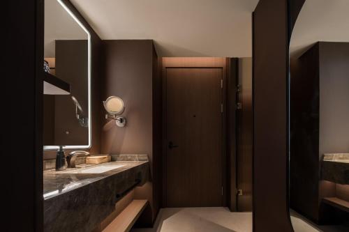 a bathroom with a sink and a mirror at Atour Hotel Haikou Longhua Jinniuling Park in Haikou