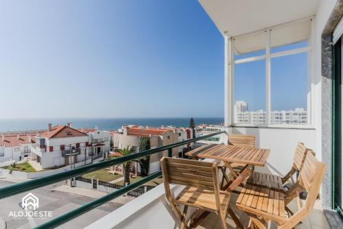 a balcony with two chairs and a table at Apartamento Vista Mar - 4 bedroom apt - Sea View in Santa Cruz