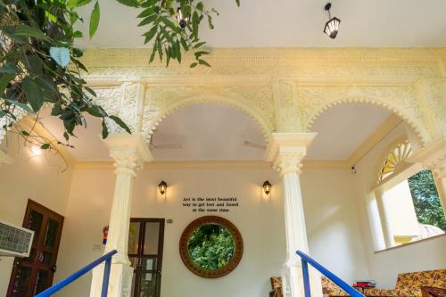 a building with columns and a wreath on the wall at Gopagiri Homestay - Gwalior in Gwalior