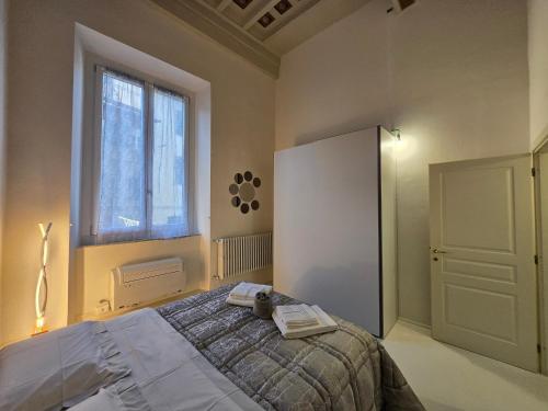 a bedroom with a bed and a window at Fabroniana apartment Elegant in Pistoia