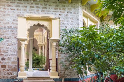 an ornate doorway to a building with a tree at Gopagiri Homestay - Gwalior in Gwalior