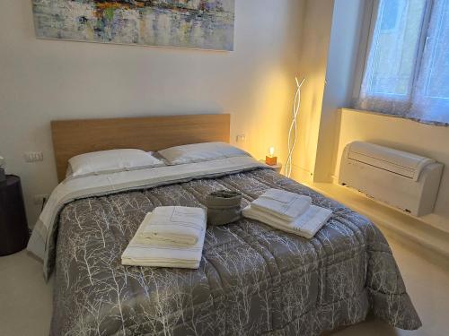 a bedroom with a bed with two towels on it at Fabroniana apartment Elegant in Pistoia