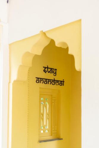 a yellow building with a sign on the side of it at Gopagiri Homestay - Gwalior in Gwalior