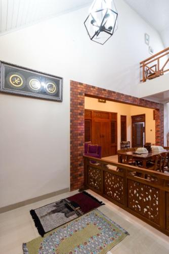 a living room with a table and a rug on the floor at Belgareti Modern Ethnic House Cipanas Puncak in Cibadak