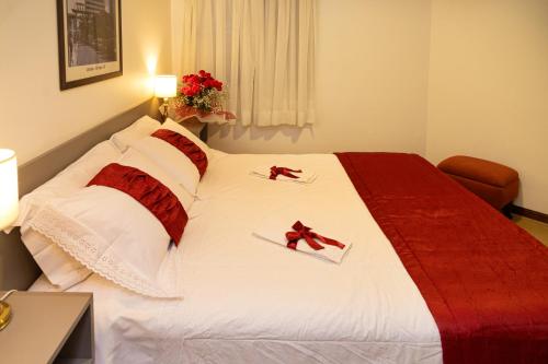 a hotel room with a bed with red bows on it at Transamerica Executive Higienópolis in Sao Paulo