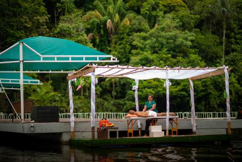 two people are sitting on a boat on the water at Uiara Amazon Resort in Manaus